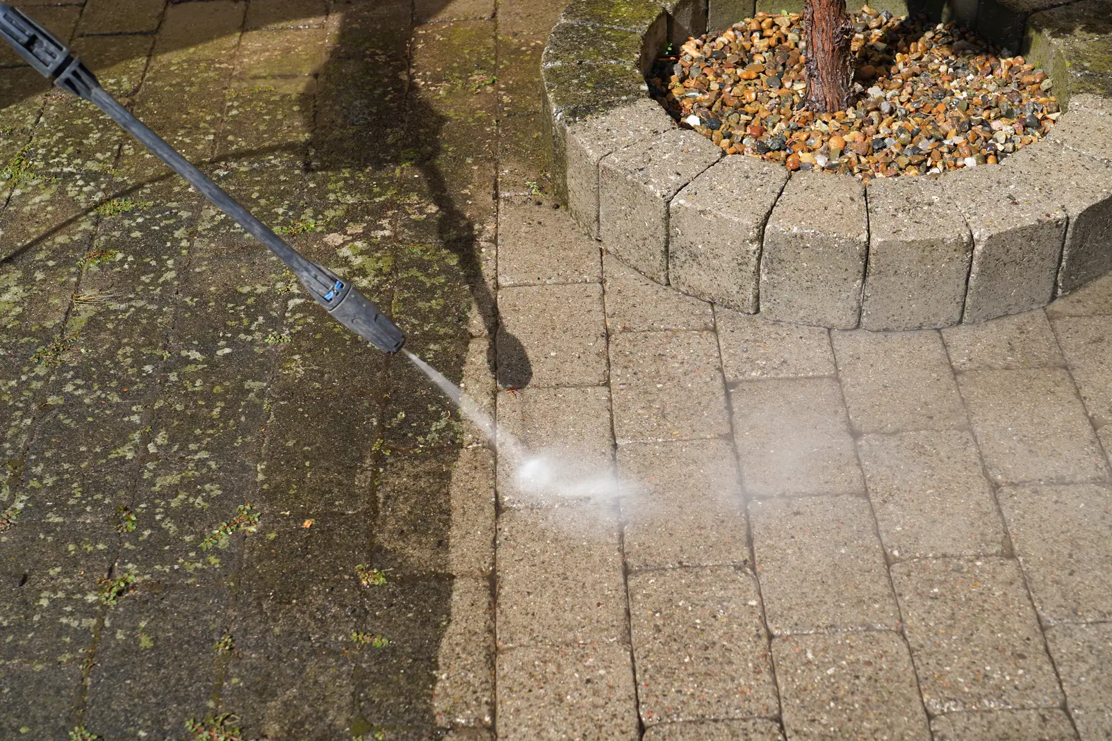 Jet washing moss and dirt from block paving