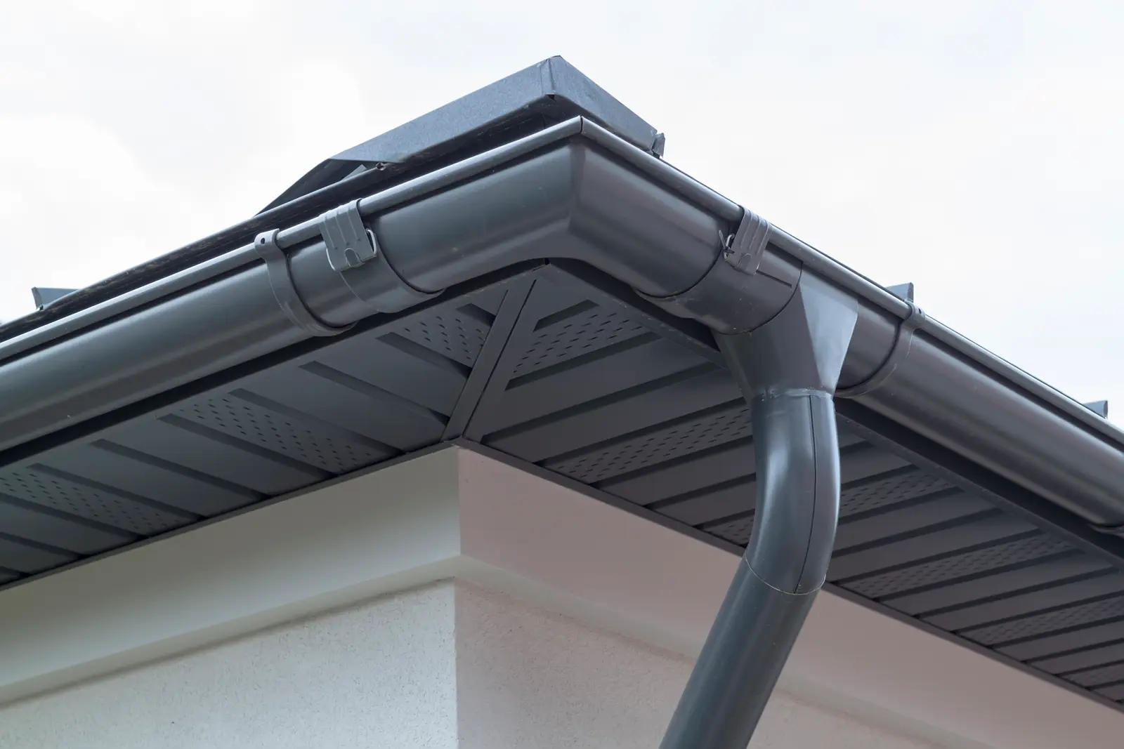 Grey uPVC fascia, soffit and gutter on a house corner