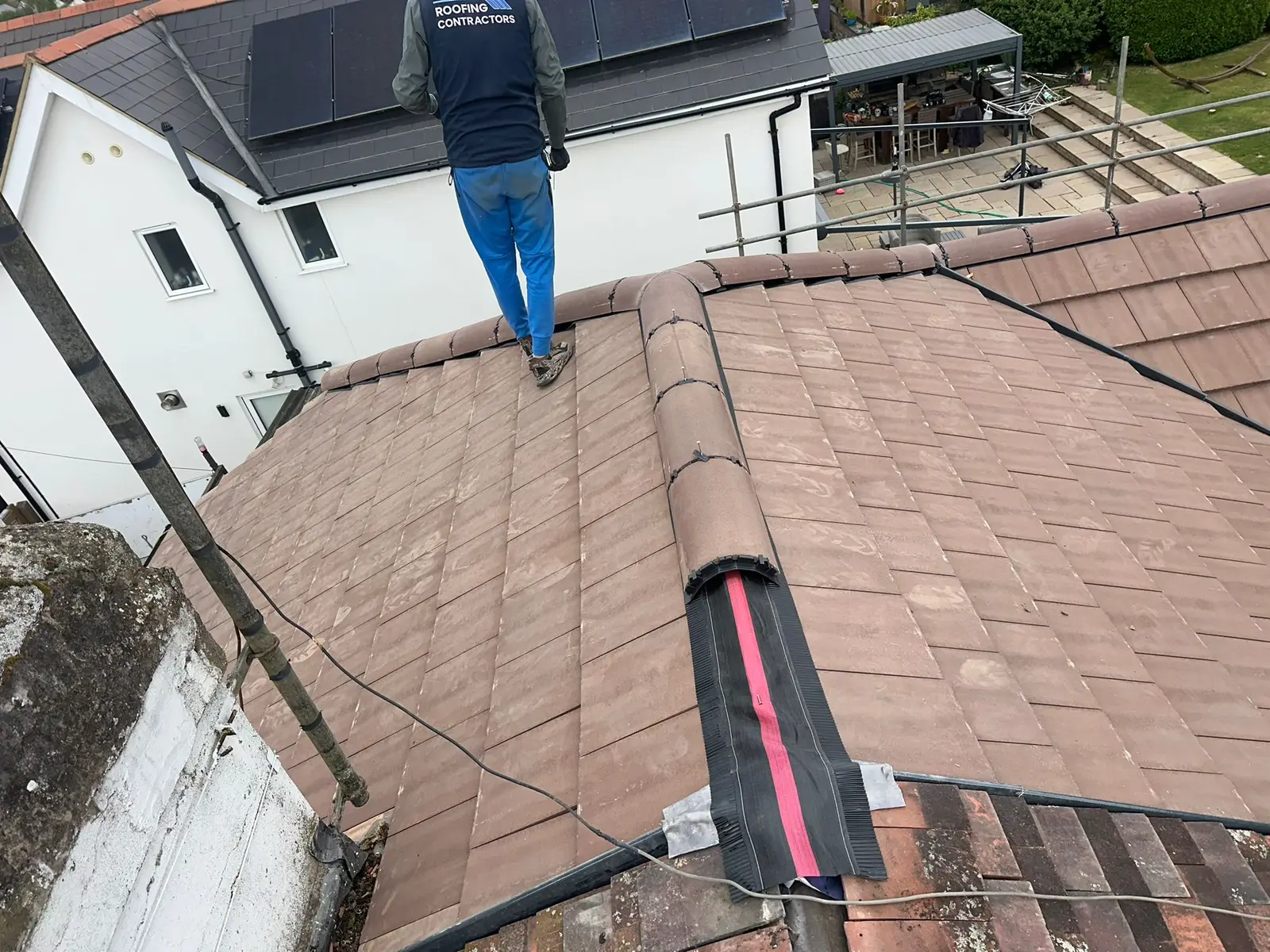 Roofer on the ridge of a new tiled roof
