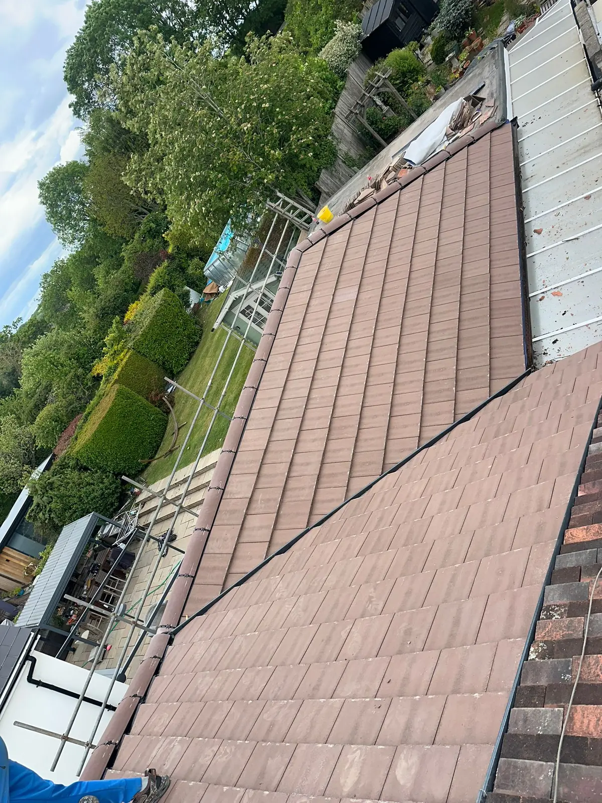 New tiled roof slope with scaffolding along the eaves