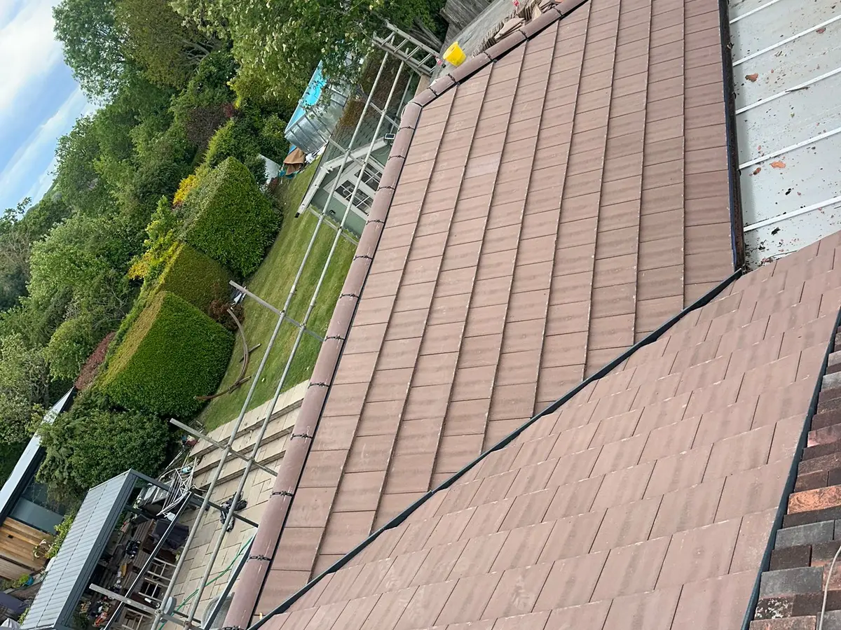 Newly tiled roof slope with scaffolding along the eaves