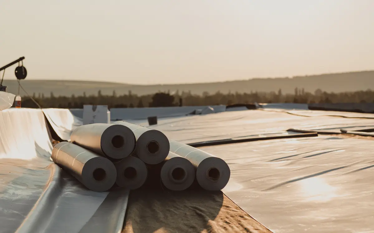 Rolls of membrane on a large commercial flat roof