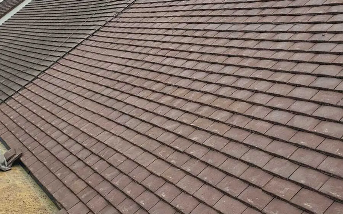 Newly tiled house roof in brown plain tiles