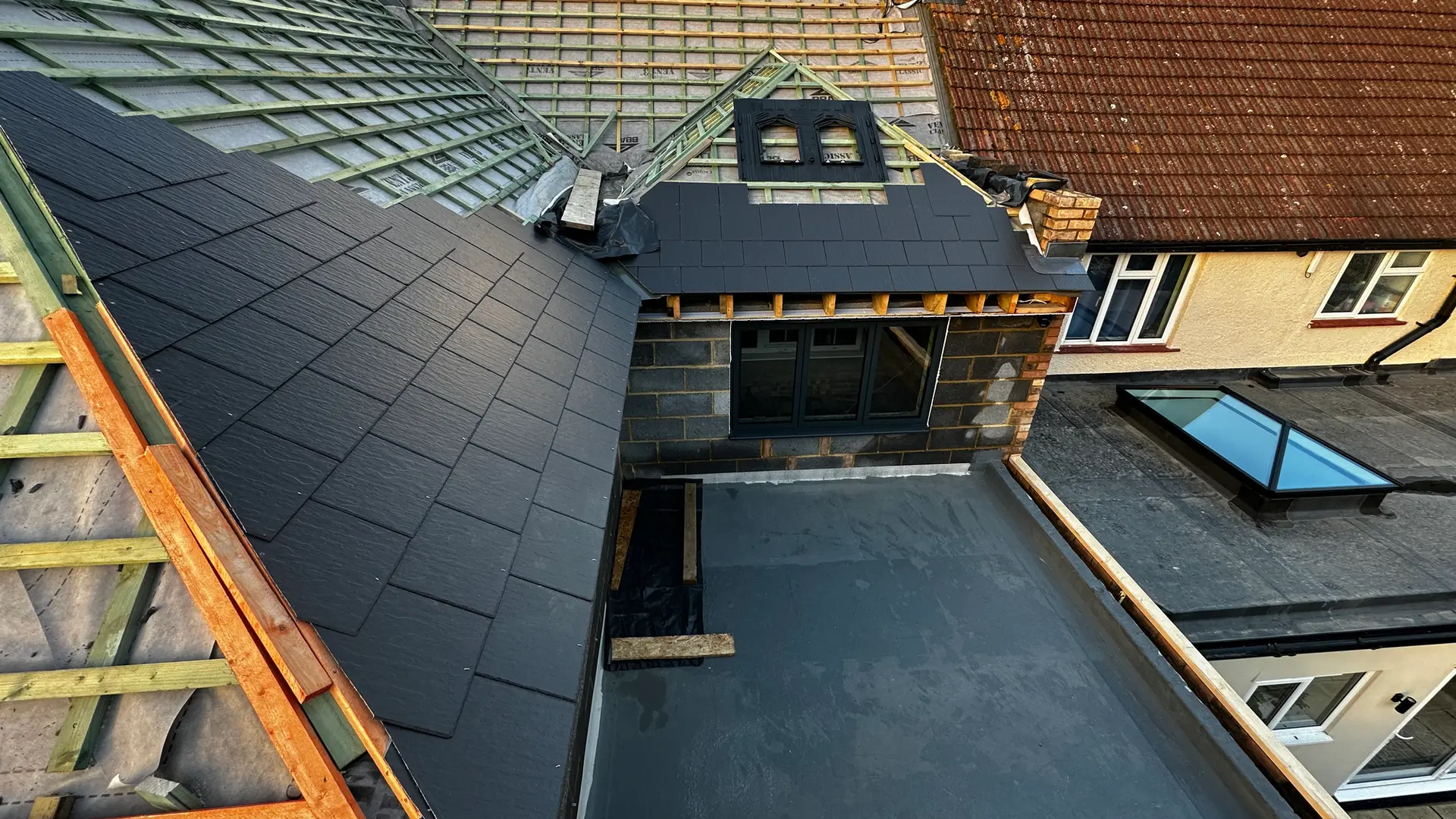 New pitched roof and flat roof with roof lights during a roofing project