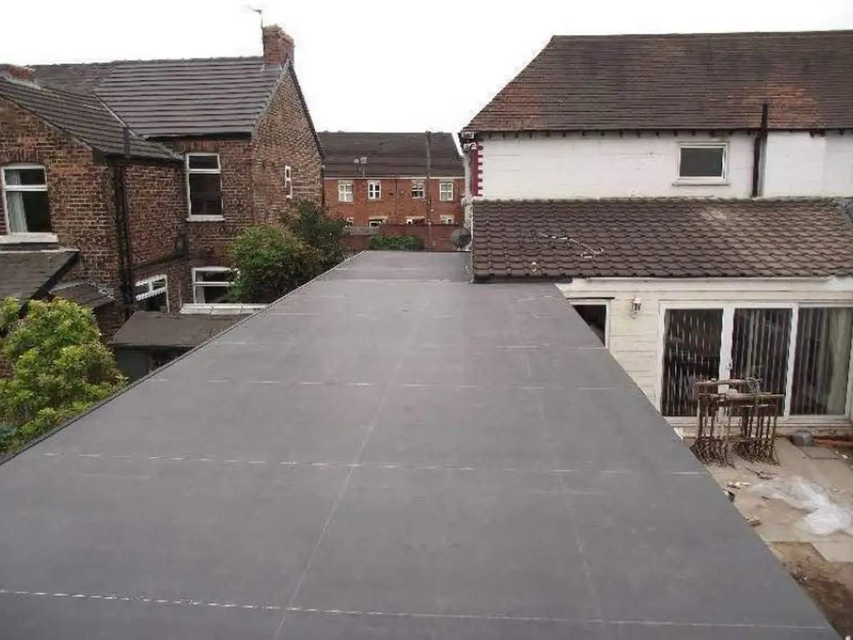 New black rubber flat roof with a roof light on an extension