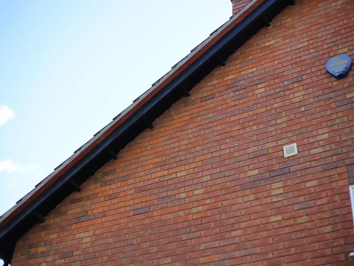 Black fascia and bargeboard on a red brick gable