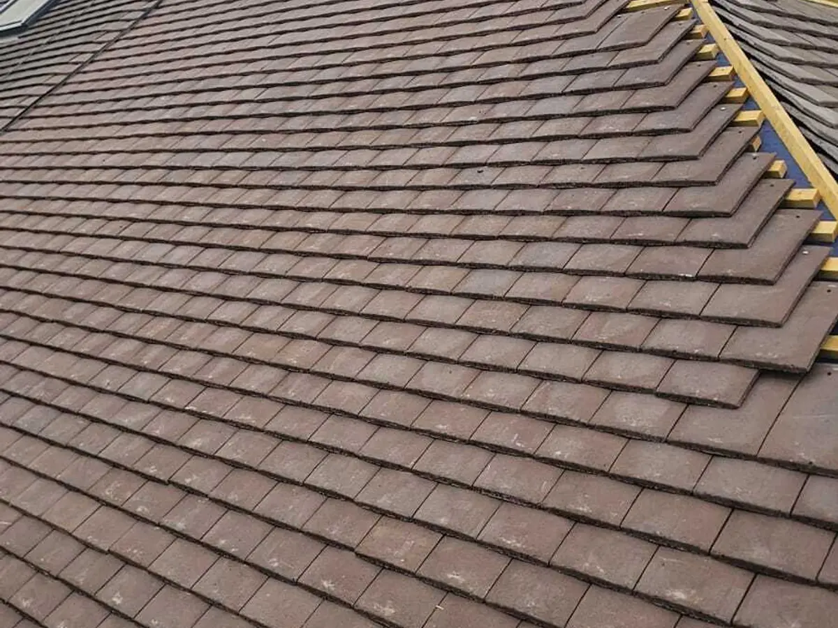 Rows of new brown plain tiles on a re-roof